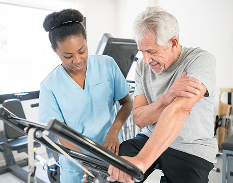 pulmonary therapist training man on stationary bike